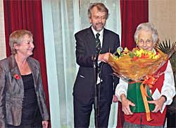 Our President, Dr. Rosalys Coope, being invited to say a few words by Chairman John Beckett after being presented with lovely flowers by Secretary, Barbara Cast (Photo: Howard Fisher).